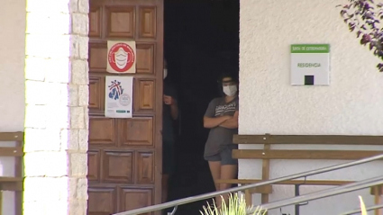 Alumnos del campamento asomados a la puerta del centro