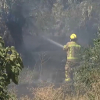Bombero apagando incendio con una manguera